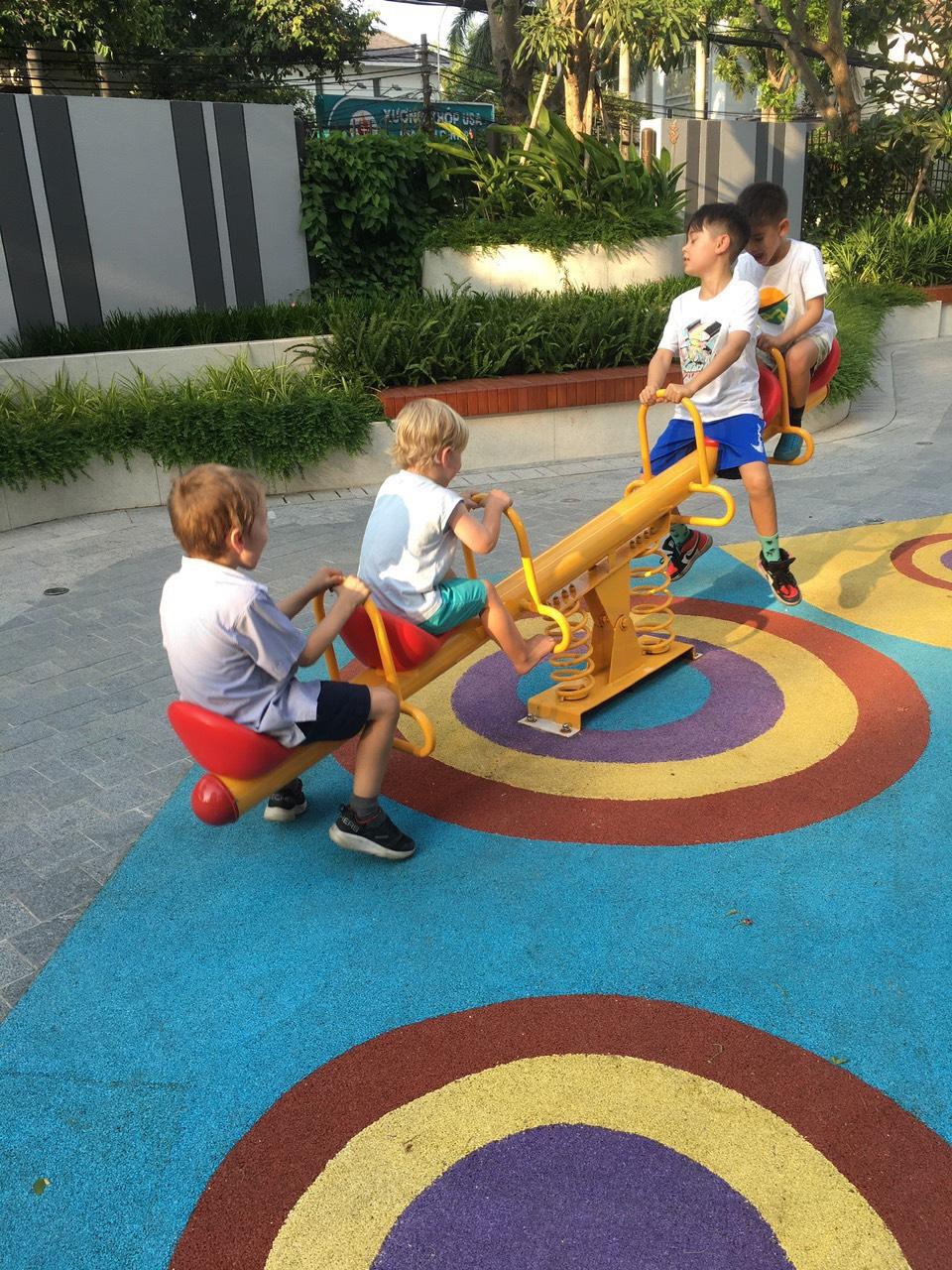 Kids enjoying a sunny day on the seesaw at the playground - English-speaking babysitter Anh Nguyen in Vietnam