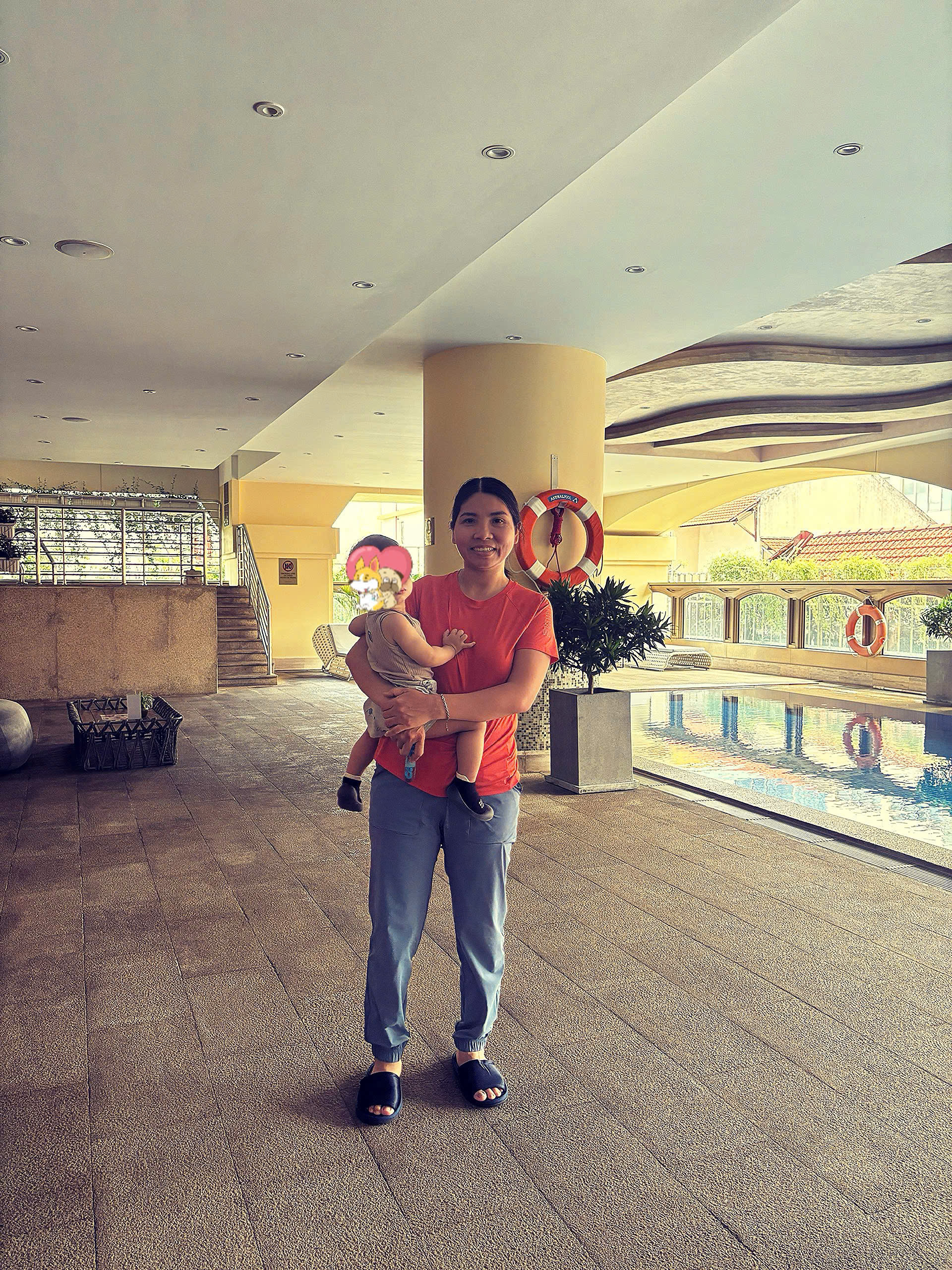 Happy family and children with English-speaking babysitter Anh Nguyen in Vietnam - Splashing around and having a great time at the swimming pool! A perfect way to cool down and have fun while practicing water safety. - Image 1